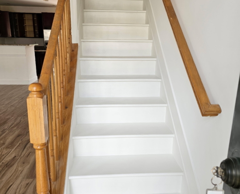 Freshly painted staircase with wooden railing